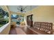 Inviting front porch with wood ceiling, wood door, porch swing, and ceiling fan at 1631 Loma Linda St, Sarasota, FL 34239