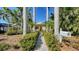 Charming home with a neatly landscaped walkway framed by tall palm trees at 1631 Loma Linda St, Sarasota, FL 34239