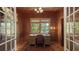 Charming home office with wood-paneled walls, natural light, and a classic desk setup at 1631 Loma Linda St, Sarasota, FL 34239