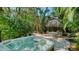 Backyard hot tub surrounded by lush tropical landscaping at 1631 Loma Linda St, Sarasota, FL 34239
