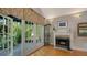 Living room showcases a fireplace, a display cabinet, and french doors that opens to a garden at 1631 Loma Linda St, Sarasota, FL 34239