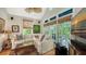 Bright living room features a comfortable sectional sofa and a wall of windows offering serene backyard views at 1631 Loma Linda St, Sarasota, FL 34239
