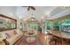 Spacious living room with vaulted ceilings, large windows, and French doors that lead to the outdoors at 1631 Loma Linda St, Sarasota, FL 34239