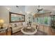 Bright living room with a large mirror, hardwood floors, comfortable seating and decor with natural light at 1631 Loma Linda St, Sarasota, FL 34239