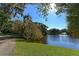 Picturesque view of a serene pond with a fountain and lush green surroundings, framed by trees and foliage at 1631 Loma Linda St, Sarasota, FL 34239
