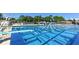 Outdoor swimming pool with blue lanes and a diving board; surrounded by lush greenery and blue and white pennants at 1631 Loma Linda St, Sarasota, FL 34239