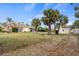 Expansive backyard with lush greenery, a shed, and mature palm trees for privacy at 17368 Norseman Ave, Port Charlotte, FL 33948