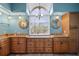 Bathroom with granite counters, custom cabinetry, and an arched window at 17368 Norseman Ave, Port Charlotte, FL 33948