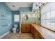 A view of the bathroom, which features granite counters, a large window, and a toilet at 17368 Norseman Ave, Port Charlotte, FL 33948
