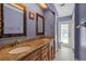 Bathroom featuring a double vanity with granite countertops and a walk-out patio at 17368 Norseman Ave, Port Charlotte, FL 33948