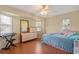 Bedroom with laminate flooring, a ceiling fan, and ample natural light from the windows at 17368 Norseman Ave, Port Charlotte, FL 33948