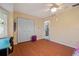 Bedroom with laminate flooring, a ceiling fan, and ample natural light from the windows at 17368 Norseman Ave, Port Charlotte, FL 33948