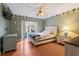 Comfortable bedroom with palm tree border, ceiling fan, and sliding doors to the patio at 17368 Norseman Ave, Port Charlotte, FL 33948
