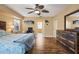 Spacious bedroom features wood floors, a ceiling fan, and a rustic wood dresser at 17368 Norseman Ave, Port Charlotte, FL 33948