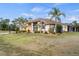 Charming home boasts lush landscaping, a neutral color scheme, and lovely architectural detailing at 17368 Norseman Ave, Port Charlotte, FL 33948