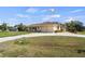 Lovely single-story home with a long driveway, attached two-car garage, and tropical landscaping at 17368 Norseman Ave, Port Charlotte, FL 33948
