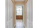 Hallway view of primary bathroom with double closets and tiled floor at 17368 Norseman Ave, Port Charlotte, FL 33948
