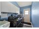 Laundry room featuring a modern black washer and dryer with white storage cabinets at 17368 Norseman Ave, Port Charlotte, FL 33948