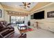 Cozy living room featuring light-colored floors, a ceiling fan, and access to the outdoor patio at 17368 Norseman Ave, Port Charlotte, FL 33948