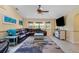 The living room features a sectional couch, a ceiling fan, and a large window at 17368 Norseman Ave, Port Charlotte, FL 33948