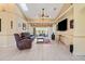 Cozy living room featuring light-colored floors, a ceiling fan, and access to the outdoor patio at 17368 Norseman Ave, Port Charlotte, FL 33948