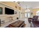 Inviting living room with wood-look floors, high ceilings, and a stylish leather furniture set at 17368 Norseman Ave, Port Charlotte, FL 33948