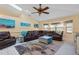Bright living room features a leather sectional couch, skylights and nautical wall decor at 17368 Norseman Ave, Port Charlotte, FL 33948