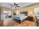 Serene bedroom featuring hard wood floors, a ceiling fan, and access to the outdoor patio at 17368 Norseman Ave, Port Charlotte, FL 33948