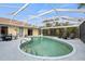 Screened-in pool with a tiled edge, lounge chairs, and a well-maintained deck at 17368 Norseman Ave, Port Charlotte, FL 33948