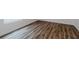 Close-up of flooring, showcasing wood-look laminate with white base trim at 1765 Jagust Rd, North Port, FL 34288