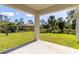 Covered patio overlooking a spacious backyard with a lawn and lush trees at 1864 Nardello Ave, North Port, FL 34288