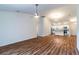Expansive living area flows into a modern kitchen, complete with wood-look flooring and an open design at 1864 Nardello Ave, North Port, FL 34288