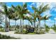 Downtown Wellen Park entrance sign surrounded by lush palm trees with string lights at 18771 Toulon Ct, Venice, FL 34293