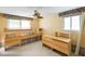 A bedroom with unfinished furniture and a ceiling fan that compliments the natural light from the two windows at 207 82Nd St, Holmes Beach, FL 34217