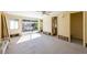 Open concept living room with a sliding glass door, ceiling fan, and bathroom entry at 207 82Nd St, Holmes Beach, FL 34217