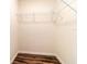 Walk-in closet with hardwood floors, shelving, and white walls at 2307 Homestead Cir, North Port, FL 34286