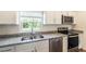Modern kitchen with granite countertops, stainless steel appliances, and white cabinetry at 2307 Homestead Cir, North Port, FL 34286