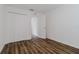 Bedroom featuring a closet with bifold doors and wood-look floors at 3267 N Chamberlain Blvd, North Port, FL 34286