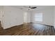 Bright bedroom with hardwood floors, white walls, a ceiling fan, and a window with blinds at 3267 N Chamberlain Blvd, North Port, FL 34286