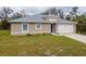 Charming single-story home with a manicured lawn and a driveway leading to a two-car garage at 3267 N Chamberlain Blvd, North Port, FL 34286