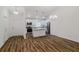 Modern kitchen with stainless steel appliances, white cabinetry, granite countertops, and hardwood floors at 3267 N Chamberlain Blvd, North Port, FL 34286