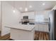 Modern kitchen with stainless steel appliances, white cabinetry, granite countertops, and a center island at 3267 N Chamberlain Blvd, North Port, FL 34286