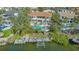 Waterfront home with private pool, dock, and boat lift, surrounded by lush landscaping and mature trees at 3491 Bayou Sound, Longboat Key, FL 34228