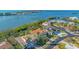An aerial view shows the luxurious property situated near the water with tropical landscaping surrounding the home at 3491 Bayou Sound, Longboat Key, FL 34228