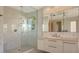Modern bathroom featuring a glass-enclosed shower and a sleek vanity with ample lighting at 3491 Bayou Sound, Longboat Key, FL 34228