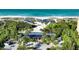 Aerial view of beach access with shaded areas, palm trees, and ocean views at 3491 Bayou Sound, Longboat Key, FL 34228