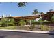 Elegant clubhouse with a tiled roof, arched entrances, lush landscaping, and paved access at 3491 Bayou Sound, Longboat Key, FL 34228