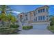 This two-story home has a front-facing two-car garage, staircase entrance, and well-maintained landscaping at 3491 Bayou Sound, Longboat Key, FL 34228