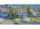 Elegant two-story home with lush landscaping, a terracotta tile roof, and inviting curb appeal in a prime location at 3491 Bayou Sound, Longboat Key, FL 34228