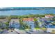 Stunning waterfront home features a Mediterranean-style design with a red tile roof and lush tropical landscaping at 3491 Bayou Sound, Longboat Key, FL 34228